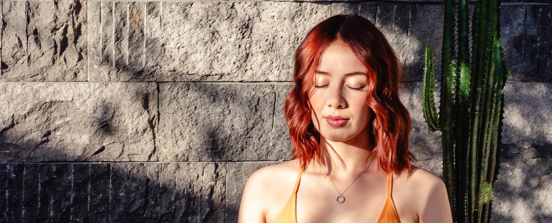 Woman meditating and practicing yoga with Monamour Essentials